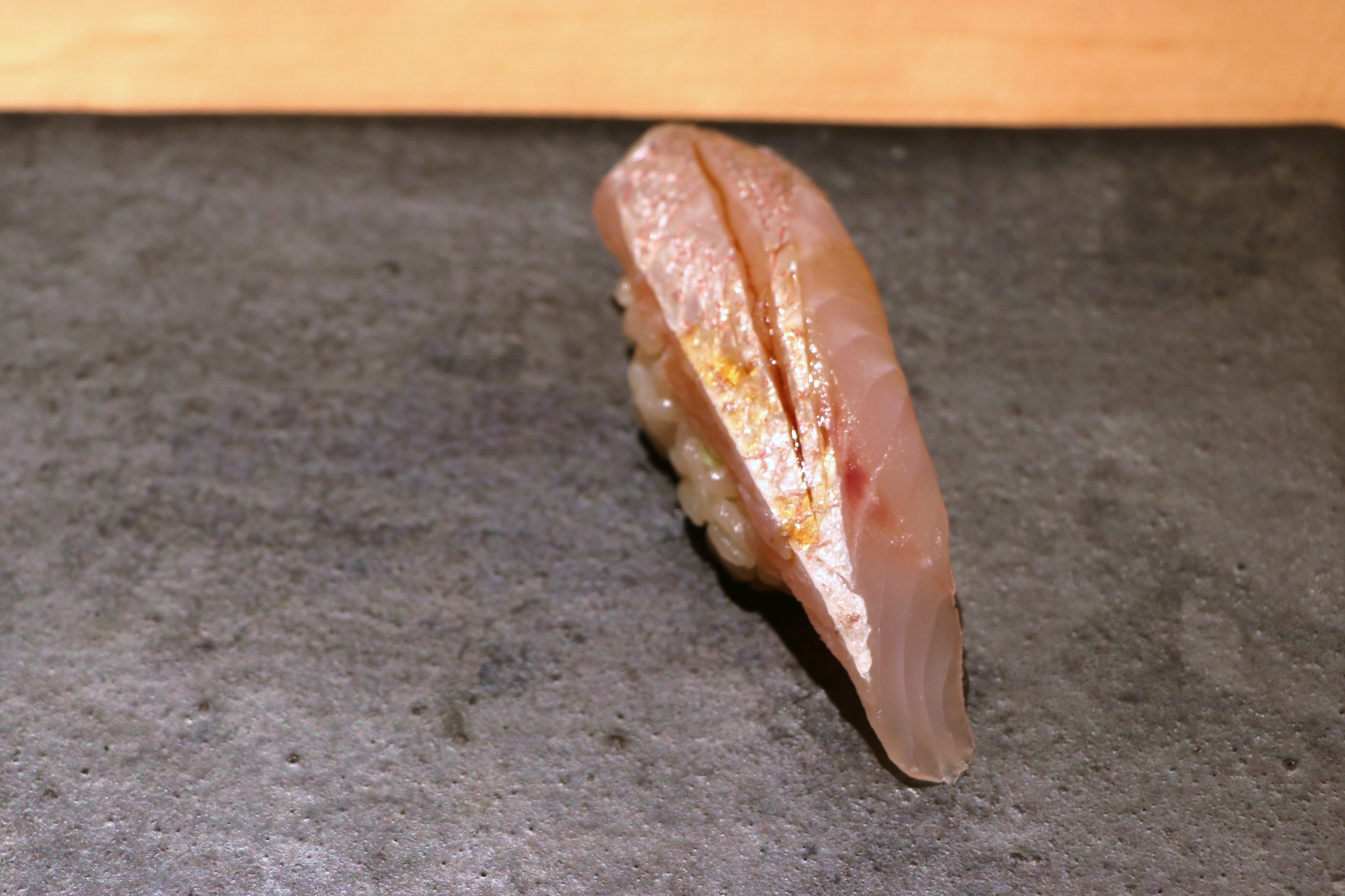 Fourteen-day aged kinme (alfonsino). Kinme is a very expensive fish in Japan that can not be wasted. Its white flesh is noted for its sweet and oily flavor. Chef Kimura’s aging process results in fish that is tender and creamy, but not broken down and mushy. Credit: Copyright 2016 Hiroko Shimbo