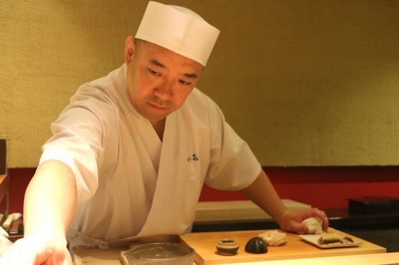 Chef Koji Kimura enjoys conversation over the sushi counter with his regulars, but his demeanor becomes much more serious when he is crafting and presenting sushi to his customers. Credit: Copyright 2016 Hiroko Shimbo